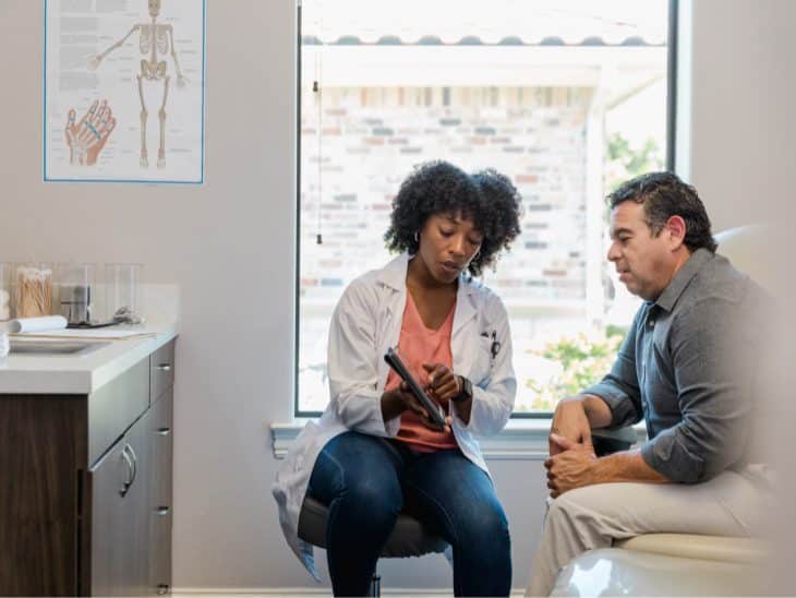 Doctor showing patient readings on tablet