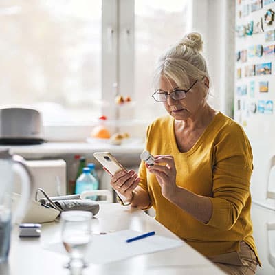 Woman Checking Medication Dosage On Phone